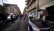 Italian Carabinieri (R) stand alert during a demonstration by Italian journalists held to defend the right to freedom of speech, in Ostia on November 10, 2017, in front of the gym owned by Roberto Spada, who was filmed allegedly headbutting Italian TV cha