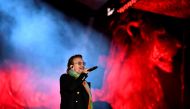 Bono of Irish rock band U2 performs with his band on stage in Trafalgar Square in central London on November 11, 2017 during the 