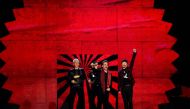 An image of Irish rock band U2, Bono (2R), The Edge (R), Adam Clayton (L) and Larry Mullen Jr (2L), accept the global icon award during the 2017 MTV Europe Music Awards (EMA) at Wembley Arena in London on November 12, 2017. / AFP / Ben STANSALL