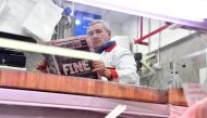 A butcher reads Italian sport newspaper 