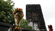 FILE PHOTO: A floral tribute is seen near the Grenfell Tower, which was destroyed in a fatal fire, in London, Britain July 15, 2017. REUTERS/Tolga Akmen/File Photo
