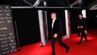 Manchester United's Portuguese manager Jose Mourinho (L) walks on the red carpet as he arrives to attend the 
