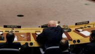 Russian Ambassador to the United Nations Vasily Nebenzya replaces his sign after waving it during a meeting of the U.N. Security Council to vote on a bid to renew an international inquiry into chemical weapons attacks in Syria, during a meeting at the U.N