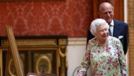 A file photo of Britain's Queen Elizabeth II and Prince Philip, Duke of Edinburgh stand next to a display of Spanish items from the Royal Collection at Buckingham Palace, London, Britain July 12, 2017. REUTERS/Neil Hall