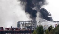 A long column of smoke rises from the Chemical plant of the BASF site in Ludwigshafen, western Germany on October 17, 2016. (AFP).