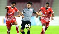 Al Rayyan striker Rodrigo Tabata (centre) is challenged by two Al Arabi players during their QNB Stars League match in Doha on Sunday.