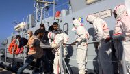 African migrants arrive at a naval base in Tripoli on November 25, 2017, after their rubber boat was rescued off the coast of Garabulli, 60 kilometres (40 miles) east of the Libyan capital. More than 30 migrants died and 200 others were rescued when their