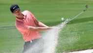 Cameron Davis of Australia hits out of a bunker during the third round of the Australian Open played at the Australian Golf Club course in Sydney on November 25, 2017./ AFP.