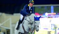 Ukrainian rider Rene Tebbel guides Cosun over an obstacle during the 160cm class of the QNB Al Rayyan International Show Jumping Championship at QEF’s Outdoor Arena yesterday.  Pictures: Lotfi Garci