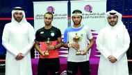 FROM LEFT: Tournament Director Saad Al Mohannadi, Egyptian player and runner-up Karim El Hammamy, Champion Qatari player Abdulla Al Tamimi and Qatar Tennis, Squash and Badminton Federation General Secretary Tariq Darwish Zainal pose for a photograph follo