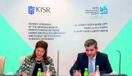 Dr. Ahmad M Hasnah, President of HBKU and Dr. Samira Omar, Director-General of KISR,  sign the agreement. 
