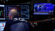 A specialist trader works at his post on the floor, as a television displays the news about former U.S. national security adviser Michael Flynn, at the New York Stock Exchange, (NYSE) in New York, U.S., December 1, 2017. (REUTERS/Brendan McDermid)