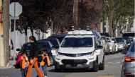 Children pass by a self-driving Chevy Bolt EV car during a media event by Cruise, GM’s autonomous car unit, in San Francisco, California, U.S. on November 28, 2017. REUTERS/Elijah Nouvelage/File Photo