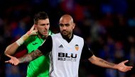 Getafe's Spanish goalkeeper Vicente Guaita (L) reacts behind Valencia's Italian forward Simone Zaza after blocking his shot on goal during the Spanish league football match Getafe CF vs Valencia CF at the Col. Alfonso Perez stadium in Getafe on December 3