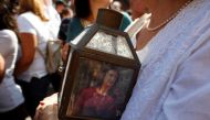 A woman holds a lantern with a picture of investigative journalist Daphne Caruana Galizia, who was assassinated in a car bomb attack, during a protest outside the law courts in Valletta, Malta, October 17, 2017. REUTERS/Darrin Zammit Lupi.