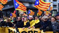 Catalonia's deposed regional president Carles Puigdemont (3-R) looks on during a pro-independence demonstration on December 7, 2017 in Brussels. Belgian police said 45,000 protesters gathered in Brussels on December 7 to show support for Catalonia's depos