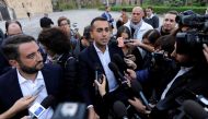 5-Star Movement Luigi Di Maio (C) and Giancarlo Cancelleri speak with media prior to a rally for a regional election in Palermo, Italy, November 3, 2017. REUTERS/Guglielmo Mangiapane/File Photo