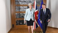 British Prime Minister Theresa May (L) and European Council President Donald Tusk leave after posing for photographers at the European Council in Brussels on December 8, 2017. ()AFP / EMMANUEL DUNAND)