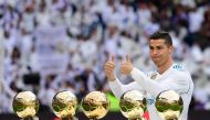 Real Madrid's Portuguese forward Cristiano Ronaldo poses with his five Ballon d'Or trophies ahead of the Spanish league football match between Real Madrid and Sevilla at the Santiago Bernabeu Stadium in Madrid on December 9, 2017. (AFP / PIERRE-PHILIPPE M