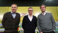 Peter Stoeger (C), new Austrian head coach of German first division Bundesliga club Borussia Dortmund, stands between Dortmund's managers Hans-Joachim Watzke (L) and Michael Zorc during a press conference where Stoeger is presented as the club's new head 