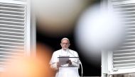 Pope Francis is pictured through the branches of a Christmas tree as he addresses the crowd from the Apostolic Palace overlooking St Peter's square during the Angelus prayer, on December 10, 2017 in Vatican. AFP / Andreas SOLARO
