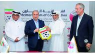 Sheikh Hamad bin Khalifa bin Ahmed Al Thani, President of the QFA and Mehdi Taj, President of the IFA along with other officials during the cooperation agreement signing ceremony at Al Bidda Tower in Doha on Thursday. 