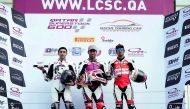 Qatar’s Saeed Al Sulaiti (centre), Nasser Al Malki (left) and Mishal Al Naimi pose for picture on the podium for Race 1 during the opening round of the Qatar Supertsock 600 at Losail International Circuit yesterday.    