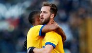 Juventus’ Miralem Pjanic celebrates with Douglas Costa after scoring their first goal from a free kick REUTERS/Alessandro Garofalo
