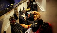 Migrants rest on the MV Aquarius, a search and rescue ship run in partnership between SOS Mediterranee and Medecins Sans Frontieres, as it approaches the Italian island of Sicily after rescue operations in the central Mediterranean off the coast of Libya,