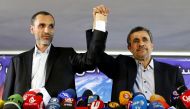 (FILES) This file photo taken on April 5, 2017 shows former Iranian president Mahmoud Ahmadinejad (R) and his former vice president, Hamid Baghaie, holding hands during a press conference in the capital Tehran. AFP / ATTA KENARE
