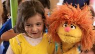 Sesame Muppet Tonton surprised a class of young students in an IRC classroom in the Bekaa Valley, Lebanon. Image from: http://refugee.sesameinternational.org/photo-gallery/