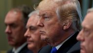 U.S. President Donald Trump, flanked by Interior Secretary Ryan Zinke, Secretary of State Rex Tillerson, and Defense Secretary James Mattis, holds a cabinet meeting at the White House in Washington, U.S., December 20, 2017. REUTERS/Jonathan Ernst.