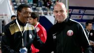 Qatar's Spanish coach Felix Sanchez (R) shakes hands with Yemen's Ethiopian coach Abraham Mebratu during their 2017 Gulf Cup of Nations football match between Qatar and Yemen at the Sheikh Jaber al-Ahmad Stadium in Kuwait City on December 23, 2017. AFP / 