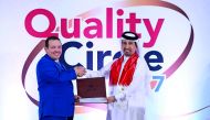 Ali bin Hassan Al Muraikhi (right), Managing Director & General Manager of Qatar Steel gives away an award to Anthony Norton Nash, HSE Manager, during the Quality Control Circle event at Al Reem Club in Mesaieed.