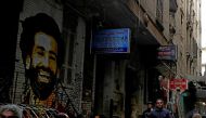 A picture of Liverpool's Egyptian midfielder Mohamed Salah is seen as people sit outside a coffee shop in Cairo, Egypt December 24, 2017. REUTERS/Amr Abdallah Dalsh