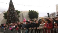 BETHLEHEM, WEST BANK - DECEMBER 24 : People gather within the 
