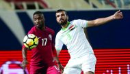 Qatari Ismail Mohammed (left) and Iraqi defender Ali Bahjat vie for the ball possession during their Group B match of the 23rd Gulf Cup Football Tournament played in Kuwait City yesterday. Pictures: Hussein Sayed