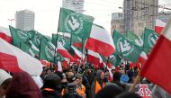 Protesters carry Polish flags and National Radical Camp (ONR) flags during a rally, organised by far-right, nationalist groups, to mark 99th anniversary of Polish independence in Warsaw, Poland November 11, 2017. Agencja Gazeta/Adam Stepien/File photo via