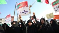 Thousands of Iranians hold banners and posters as they take part in a pro-government rally in Mashhad, Iran on January 4, 2018. (Nima Najafzadeh/ Anadolu)