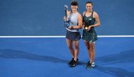 Elina Svitolina of Ukraine (L) holds up the winner's trophy beside Aliaksandra Sasnovich of Belarus after winning their women's singles final of the Brisbane International tennis tournament at the Pat Rafter Arena in Brisbane on January 6, 2018.  AFP / Sa