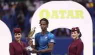 Gael Monfils of France holds the winner's trophy after winning against Russia's Andrey Rublev in the ATP Qatar Open tennis competition in Doha on January 6, 2018. Monfils won the Qatar Open final in straight sets, brushing aside Rublev in a one-sided fina