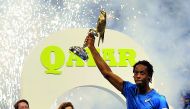 Qatar ExxonMobil Open 2018 champion Gaël Monfils celebrates with the trophy at the Khalifa International Tennis and Squash Complex in Doha yesterday. Picture by Kammutty VP / The Peninsula