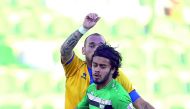 Al Gharafa’s Dutch midfielder Wesley Sneijder (in yellow) is challenged by a Al Ahli player during the QNB Stars League match at the Al Ahli Stadium in Doha yesterday.