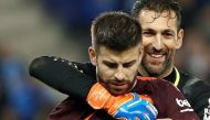 RCD Espanyol's goalkeeper Diego Lopez (R) embraces Gerard Pique (L) of FC Barcelona at the end of their Spanish King's Cup quarterfinals first leg match played at the RCD Stadium in Cornella, Barcelona, Spain, 17 January 2018. EPA/ANDREU DALMAU
