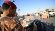 Iraqi soldiers control one of several checkpoints they set up along the main 50 kilometre road between the area of Karmat Ali on the northern outskirts of Basra and the town of Al Dayr.