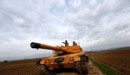 Turkish soldiers prepare their tanks near the Syrian-Turkish border, at Reyhanli district in Hatay, Turkey, 21 January 2018. EPA/SEDAT SUNA
