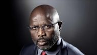 (FILES) This file photo taken on September 25, 2017 shows former football player and candidate in Liberia's presidential elections, George Weah posing during a photo session in Paris.   AFP / JOEL SAGET
