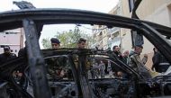 Lebanese security forces check a damaged vehicle following a car bomb blast in the southern Lebanese. AFP