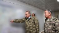  Turkey's President Recep Tayyip Erdogan (L), accompanied by Chief of the General Staff of the Turkish Armed Forces Hulusi Akar, gesturing during a briefing at the Operating Base in Hatay, on the sixth day of 'Operation Olive Branch.' AFP Photo / Turkish 
