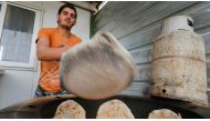 A Syrian refugee makes bread to sell at the Zaatari refugee camp in Mafraq, Jordan, January  8, 2015. Reuters/Muhammad Hamed